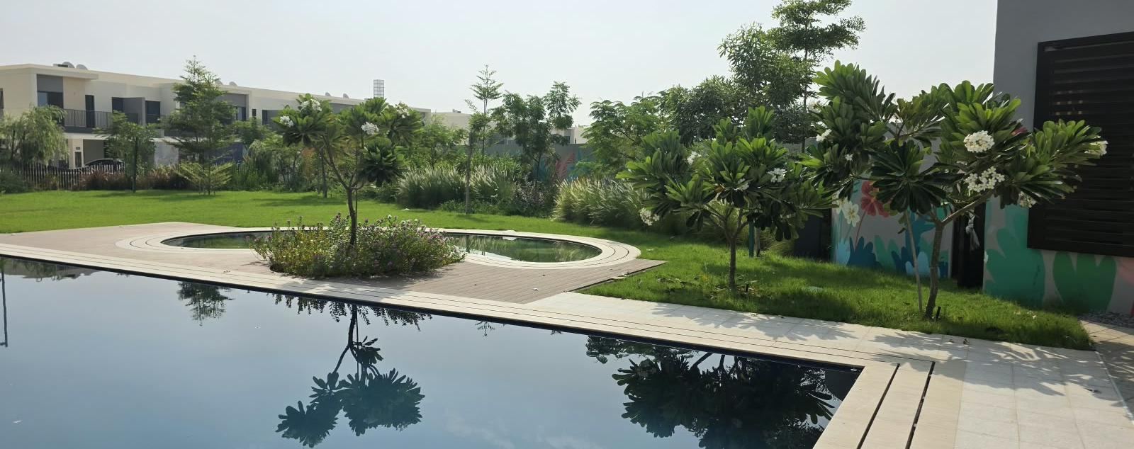 Landscaped shared garden with reflecting pool at Al Mouj, Muscat